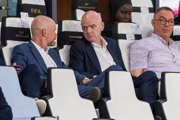 FIFA president Gianni Infantino, center, speaks to FIFA secretary general Mattias Grafstrom, left, sitting beside president of Moroccan Royal Football Federation Fouzi Lekjaa as they attend a Women