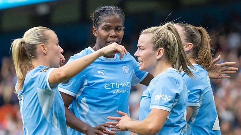 Manchester City players celebrate against Arsenal